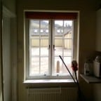 White aluminium secondary glazing face fixed into existing timber window.