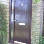 Rosewood GRP Composite front door with a Rosewood uPVC outerframe, sidelight and gold colour furniture