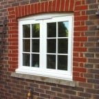 White painted hardwood windows with surface mounted Georgian Bars, Monkey Tail handles and a 4000 trickle vent in the head frame