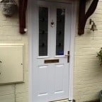 White GRP composite door with Gold colour furniture