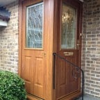 Golden Oak GRP Composite front door with matching colour outerframe and gold colour furniture