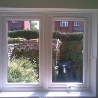 White uPVC window with a dummy casement for equal sight lines and a 4000 trickle vent in the opening casement