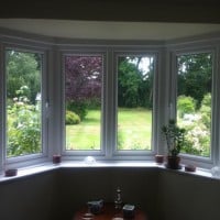 White uPVC window with chamfered framing and dummy casements for equal sight lines
