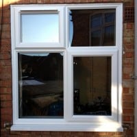 White uPVC window with chamfered framing and a 4000 trickle vent in the fanlight