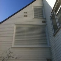 White uPVC windows with white powder coated aluminium fixed louvres