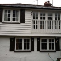 A-rated White uPVC windows with fully sculptured framing, surface mounted Georgian Bars and black antique style monkeytail handles