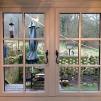 A-rated White uPVC window with fully sculptured framing, surface mounted Georgian Bars and black antique style monkeytail handles