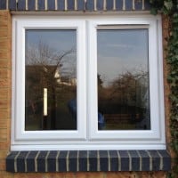 White uPVC window with fully sculptured framing and a dummy casement for equal sight line. 4000 trickle vent in casement.