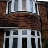 Externally glazed white uPVC Swiftframe profile chamfered framing windows with dummy casements for equal sight lines
