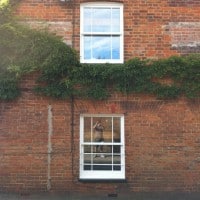 White painted hardwood sliding sash window with surface mounted Georgian Bars