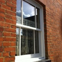 White painted hardwood sliding sash window with surface mounted Georgian Bars