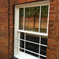 White painted hardwood sliding sash window with surface mounted Georgian Bars