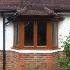 Light Oak uPVC windows with chamfered framing and dummy casements for equal sight lines