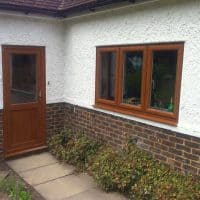 Light Oak uPVC windows with chamfered framing and dummy casements for equal sight lines
