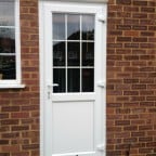 White Liniar profile uPVC back door – bevelled beading and framing.  18mm internal Georgian bars with clear glass