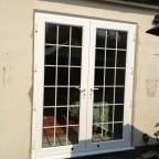 White Swiftframe uPVC.  Bevelled framing and beading.  Internal 18mm white Georgian bars and white handles.