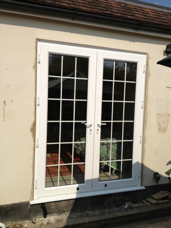 White Swiftframe uPVC. Bevelled framing and beading. Internal 18mm white Georgian bars and white handles.