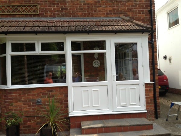 White uPVC Swiftframe profile. Bevelled frame and beading. White uPVC decorative panels in lower sections and clear toughened glass in the upper sections.