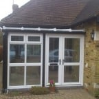 White uPVC entrance porch/conservatory with black uPVC trims to imitate original timber