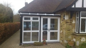 White uPVC entrance porch/conservatory with black uPVC trims to imitate original timber