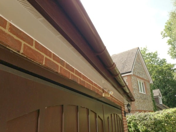 Rosewood coloured uPVC fascia board white vented uPVC soffit board and brown half round deepflow uPVC guttering