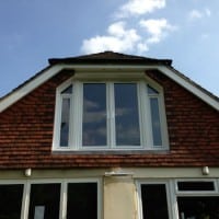 White uPVC fully sculptured Liniar profile A rated double glazed French doors and two tilt and turn windows