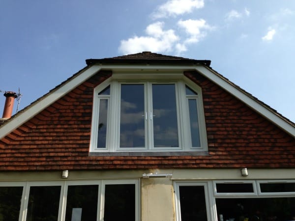 White uPVC fully sculptured Liniar profile A rated double glazed French doors and two tilt and turn windows