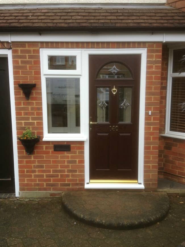 Darkwood out/white in composite door with White PVCu side window.