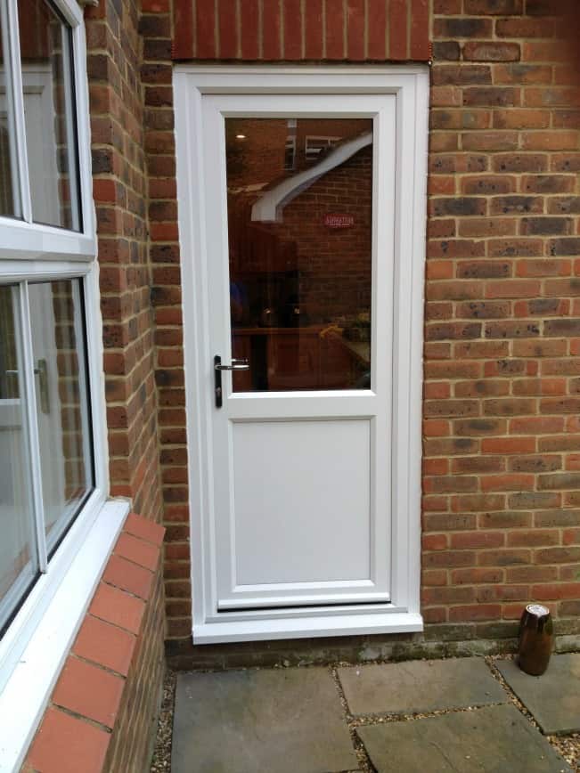 White Liniar uPVC door with multi-point locks operated by chrome leverlever handles.