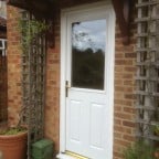 White in and out GRP composite back door with gold colour furniture