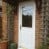 White in and out GRP composite back door with gold colour furniture