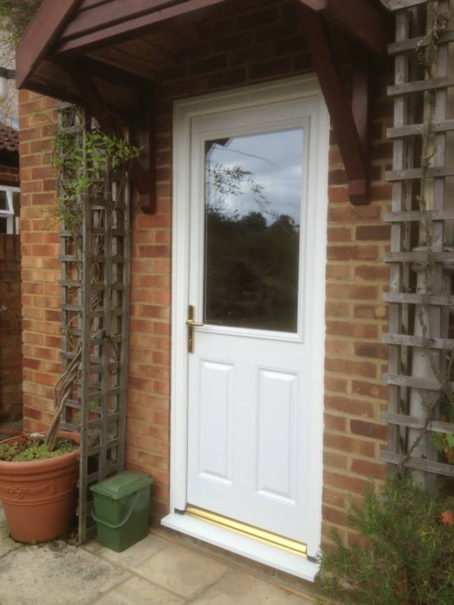 White in and out GRP composite back door with gold colour furniture