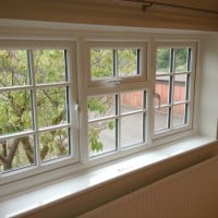 White uPVC Liniar profile with surface mounted Georgian Bars.