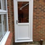 White Liniar uPVC door with multi-point locks operated by chrome leverlever handles.