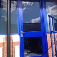 Blue aluminium fire door in Leatherhead