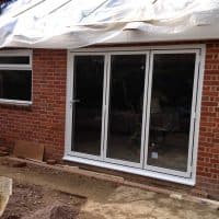 white-aluminium-double-glazed-aluminium-bifolding-doors-by-dorking-glass-in-surrey